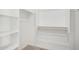 A well-organized closet featuring white shelving and wooden hanging rods at 5335 W Manzanita Dr, Glendale, AZ 85302