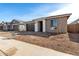 View of the front of a single-Gathering home with desert landscaping and a two-car garage at 5335 W Manzanita Dr, Glendale, AZ 85302