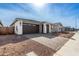 Charming single-story home featuring a brick driveway, a two-car garage, and neutral-toned stucco exterior at 5335 W Manzanita Dr, Glendale, AZ 85302