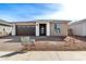 Single-story home featuring a two-car garage, a neutral-toned stucco exterior, and a brick driveway at 5335 W Manzanita Dr, Glendale, AZ 85302
