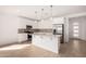Bright kitchen boasts white cabinetry, stainless steel appliances, and a large center island with pendant lighting at 5335 W Manzanita Dr, Glendale, AZ 85302