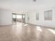 Open living room with neutral flooring, recessed lighting, and sliding glass doors leading to the backyard at 5335 W Manzanita Dr, Glendale, AZ 85302