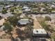 Aerial view of the home in a quiet neighborhood with mature trees and desert landscaping at 26415 S Recker Rd, Queen Creek, AZ 85142