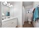 Bathroom features a white vanity, a tiled floor, and a shower with a curtain at 26415 S Recker Rd, Queen Creek, AZ 85142