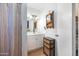 Bathroom features a vanity with storage and decorative accents at 26415 S Recker Rd, Queen Creek, AZ 85142