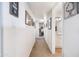 Hallway with neutral carpet, art-lined walls, and leading to a bathroom and bedroom at 26415 S Recker Rd, Queen Creek, AZ 85142