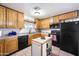 Charming kitchen featuring wooden cabinets, black appliances, and a central island at 26415 S Recker Rd, Queen Creek, AZ 85142