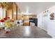 Kitchen with wood cabinets, dark appliances, tile countertops and a breakfast bar at 26415 S Recker Rd, Queen Creek, AZ 85142