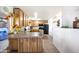 Bright kitchen featuring wood cabinets, black appliances, and a breakfast bar at 26415 S Recker Rd, Queen Creek, AZ 85142