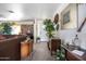 Living room with traditional decor, plants, and a view to the front door at 26415 S Recker Rd, Queen Creek, AZ 85142