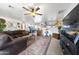 Open-concept living room with hardwood furniture and a ceiling fan with light fixture at 26415 S Recker Rd, Queen Creek, AZ 85142