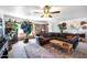 Inviting living room featuring a stone fireplace, a brown sectional, and large potted plants at 26415 S Recker Rd, Queen Creek, AZ 85142