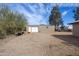 Detached outbuilding featuring multiple access doors and large dirt area around it at 26415 S Recker Rd, Queen Creek, AZ 85142
