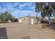 Detached outbuilding featuring multiple access doors and large dirt area around it at 26415 S Recker Rd, Queen Creek, AZ 85142