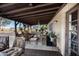 Cozy covered patio featuring comfortable seating, ceiling fan, and brick accent wall at 26415 S Recker Rd, Queen Creek, AZ 85142