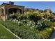 Lush landscaping surrounds the exterior of the home, creating an inviting curb appeal at 11179 E Honda Bow Rd, Scottsdale, AZ 85262