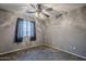 Well-lit bedroom with ceiling fan and window at 22142 N Braden Rd, Maricopa, AZ 85138