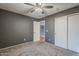 Cozy bedroom with ceiling fan and grey walls at 22142 N Braden Rd, Maricopa, AZ 85138