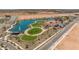 Aerial view of community park and lake with playground and clubhouse at 1205 W Golden Ore Pass, Apache Junction, AZ 85120