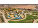 Aerial view of unique community playground and surrounding green spaces at 1205 W Golden Ore Pass, Apache Junction, AZ 85120