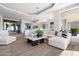 Bright living room features a comfy sectional sofa and large windows at 12943 E Corrine Dr, Scottsdale, AZ 85259