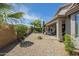 A well-maintained backyard with desert landscaping features a covered patio and ample open space at 34 N Agua Fria Ln, Casa Grande, AZ 85194