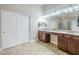 Bathroom featuring double sinks, spacious counter space, and ample storage at 34 N Agua Fria Ln, Casa Grande, AZ 85194
