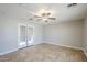 Neutral bedroom with tiled floors, a ceiling fan and a door that goes to the outside at 34 N Agua Fria Ln, Casa Grande, AZ 85194