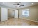Spacious bedroom with a ceiling fan, tile flooring and an open doorway to another room at 34 N Agua Fria Ln, Casa Grande, AZ 85194