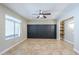 Neutral bedroom featuring a ceiling fan, tile flooring, a window, and a built-in bookshelf at 34 N Agua Fria Ln, Casa Grande, AZ 85194