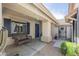 Inviting front porch with a wicker bench and stylish blue shutters and door at 34 N Agua Fria Ln, Casa Grande, AZ 85194