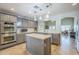 Well-appointed kitchen with gray cabinets, stainless steel appliances, tile backsplash and center island at 34 N Agua Fria Ln, Casa Grande, AZ 85194
