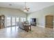 Bright living room featuring tile floors, a ceiling fan, and access to the outdoors at 34 N Agua Fria Ln, Casa Grande, AZ 85194