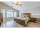 Inviting main bedroom featuring a large window, neutral paint, and a ceiling fan at 34 N Agua Fria Ln, Casa Grande, AZ 85194