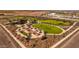 Aerial view of community park with bocce ball courts and green spaces at 10211 S Bickwell Trl, Apache Junction, AZ 85120