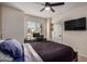 Bedroom with ceiling fan, TV and desk near window with view at 11035 E Clinton St, Scottsdale, AZ 85259
