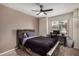 Bedroom features ceiling fan, window with view, and desk area at 11035 E Clinton St, Scottsdale, AZ 85259