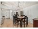 Dining area with tall ceilings, a modern light fixture, and seating for six at 11035 E Clinton St, Scottsdale, AZ 85259