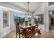 Bright dining area with a wooden table, bench seating, and a view of the pool outside at 11035 E Clinton St, Scottsdale, AZ 85259