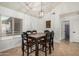 Cozy dining space with a wooden table, seating for six, and a view from the window at 11035 E Clinton St, Scottsdale, AZ 85259