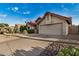 Charming single story home with a red tile roof, two car garage, and desert landscaping at 11035 E Clinton St, Scottsdale, AZ 85259