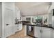 An open kitchen features black marble countertops, stainless steel appliances, and white cabinets at 11035 E Clinton St, Scottsdale, AZ 85259
