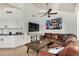 Cozy living room with vaulted ceilings, a brown leather sofa, and a view to the kitchen bar at 11035 E Clinton St, Scottsdale, AZ 85259