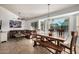Open concept living area features a leather sofa, modern art, and views of the backyard at 11035 E Clinton St, Scottsdale, AZ 85259