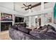 Cozy living room with a fireplace, large TV, and comfortable seating with vaulted ceiling at 11035 E Clinton St, Scottsdale, AZ 85259