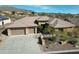 Single-story home with tile roof, large driveway, and desert landscaping at 42023 N Bridlewood Way, Phoenix, AZ 85086