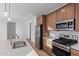 Modern kitchen with stainless steel appliances and light wood cabinets at 8332 N 54Th Ln, Glendale, AZ 85302