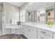 Bright bathroom features double sinks with white cabinets, a large mirror, and a separate tub and shower at 2229 N Beverly Pl, Buckeye, AZ 85396