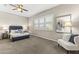 Cozy primary bedroom featuring a ceiling fan, comfortable seating and plenty of natural light at 2229 N Beverly Pl, Buckeye, AZ 85396