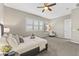 Light filled primary bedroom featuring a ceiling fan, comfortable seating and natural light at 2229 N Beverly Pl, Buckeye, AZ 85396